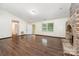 Bright living area with hardwood floors, a brick fireplace, natural light, and access to other rooms at 1802 Deer St, Charlotte, NC 28214