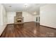 Spacious living room features a brick fireplace, hardwood floors, neutral walls, and a vaulted ceiling at 1802 Deer St, Charlotte, NC 28214