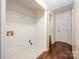 Utility room with washer hookups, wire rack shelves and tile floors at 1802 Deer St, Charlotte, NC 28214
