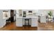 Kitchen area features an island, white cabinets, stainless steel appliances, and sleek modern design at 1806 Asbury Hall Ct, Charlotte, NC 28209