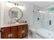 A well-lit bathroom featuring double sinks and a glass shower with marble tiling at 2114 Thurmond Pl, Charlotte, NC 28205