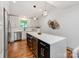 Bright kitchen with white countertops, stainless steel appliances, and sleek dark cabinetry on the island at 2114 Thurmond Pl, Charlotte, NC 28205