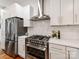 Contemporary kitchen featuring stainless steel oven and hood, sleek countertops and tiled backsplash at 2114 Thurmond Pl, Charlotte, NC 28205