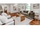 Inviting living room featuring a olive couch, a rustic wood coffee table and plenty of seating at 2114 Thurmond Pl, Charlotte, NC 28205