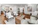 Open concept living room with a wooden coffee table, hardwood floors, and white furniture at 2114 Thurmond Pl, Charlotte, NC 28205