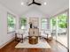 Bright living room featuring stylish armchairs, a decorative rug, and natural light from large windows at 2114 Thurmond Pl, Charlotte, NC 28205