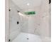 A modern glass shower enclosure with marble walls and contemporary fixtures at 2114 Thurmond Pl, Charlotte, NC 28205
