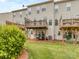 View of a well-maintained backyard with grass, mulch, grill, and wooden decks attached to the house at 2169 Belle Vernon Ave, Charlotte, NC 28210