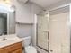 Functional bathroom featuring a shower with glass doors, toilet, and a vanity sink at 2169 Belle Vernon Ave, Charlotte, NC 28210