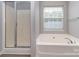 Bathroom featuring a shower and jetted tub beneath a window at 2169 Belle Vernon Ave, Charlotte, NC 28210