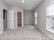 Bedroom with neutral walls, carpet, a double door to closet and a window at 2169 Belle Vernon Ave, Charlotte, NC 28210