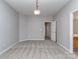 Bright bedroom features neutral walls, carpet, and two doors, one to closet at 2169 Belle Vernon Ave, Charlotte, NC 28210