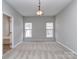 Bright bedroom features neutral walls, carpet, and natural light from two windows at 2169 Belle Vernon Ave, Charlotte, NC 28210