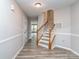 Welcoming entryway with light gray walls, staircase, wood-look flooring, and a neutral color scheme at 2169 Belle Vernon Ave, Charlotte, NC 28210