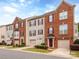 Attractive townhomes with brick and siding, red shutters, attached garages, and well-maintained lawns at 2169 Belle Vernon Ave, Charlotte, NC 28210