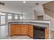 A kitchen with wood cabinets, stainless steel sink, dishwasher, and grey countertops at 2169 Belle Vernon Ave, Charlotte, NC 28210