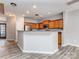 A kitchen with wood cabinets, stainless steel appliances, and a breakfast bar with grey countertop at 2169 Belle Vernon Ave, Charlotte, NC 28210