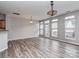 Open-concept living room with gray walls, wood-look flooring, and a door to the backyard at 2169 Belle Vernon Ave, Charlotte, NC 28210