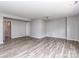 Versatile living area with wood-look floors, neutral walls, and a projector mount for entertainment options at 2169 Belle Vernon Ave, Charlotte, NC 28210