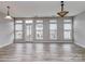Open living room area with wood-look floors, neutral walls, and an array of windows for natural light at 2169 Belle Vernon Ave, Charlotte, NC 28210