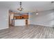 Open-concept living area with wood-look flooring and kitchen with stainless steel appliances and wooden cabinets at 2169 Belle Vernon Ave, Charlotte, NC 28210