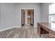 Office featuring French doors, wood-look flooring, and a wooden desk at 2169 Belle Vernon Ave, Charlotte, NC 28210