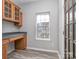 Office with built-in wood cabinets, grey countertops, and a window at 2169 Belle Vernon Ave, Charlotte, NC 28210
