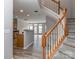 Carpeted staircase with wood railing leading to the upper level, open to the living room and kitchen at 2169 Belle Vernon Ave, Charlotte, NC 28210