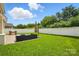 Spacious backyard featuring lush green grass, a patio area, and a built-in barbecue grill, perfect for outdoor entertaining at 2233 Sonoma Valley Dr, Charlotte, NC 28214