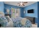 Cozy blue bedroom with a large bed, ceiling fan, and natural light from the window at 2233 Sonoma Valley Dr, Charlotte, NC 28214