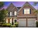 Charming two-story home boasts a manicured lawn, stone accents, and a two-car garage at 2233 Sonoma Valley Dr, Charlotte, NC 28214
