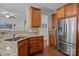 Kitchen sink and counter with stainless appliances and hardwood flooring into stairway at 2233 Sonoma Valley Dr, Charlotte, NC 28214