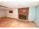 Unfinished basement featuring a brick fireplace with dark metal doors and a hearth at 2625 Glenn St, Newton, NC 28658