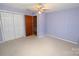 Bedroom featuring carpeted floors, a ceiling fan, and a closet with white bi-fold doors at 2625 Glenn St, Newton, NC 28658