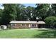 Charming brick home with a well-manicured lawn and a covered carport, perfect for easy parking at 2625 Glenn St, Newton, NC 28658