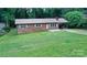 Well-maintained single-story brick home featuring a covered carport and a neatly landscaped front yard at 2625 Glenn St, Newton, NC 28658