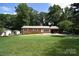 Charming brick home with a metal roof, spacious front yard, and a convenient carport at 2625 Glenn St, Newton, NC 28658