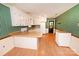 Bright kitchen with light wood floors, white cabinets and appliances, and a breakfast bar at 2625 Glenn St, Newton, NC 28658