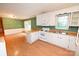 Bright kitchen features white cabinets and appliances, an island, and access to the living room at 2625 Glenn St, Newton, NC 28658