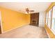 Sunny living room features a brick fireplace, built-in shelving, carpet and large windows at 2625 Glenn St, Newton, NC 28658