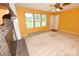 Bright living room featuring a brick fireplace, carpet, windows, and white trim at 2625 Glenn St, Newton, NC 28658