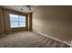 Cozy bedroom with a ceiling fan, carpeted floors, and a window overlooking the outside at 3208 Barons Court Rd, Charlotte, NC 28213