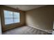 This bedroom has neutral paint and carpet with a window at 3208 Barons Court Rd, Charlotte, NC 28213