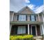 Charming two-story townhouse with brick accents, dark shutters and a well-manicured front yard at 3208 Barons Court Rd, Charlotte, NC 28213