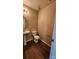 Clean and efficient powder room with a pedestal sink, toilet, and hardwood floors at 3208 Barons Court Rd, Charlotte, NC 28213