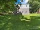 Expansive backyard with lush green grass, mature trees, and ample space for outdoor activities at 322 Peachtree St, Albemarle, NC 28001