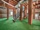 Unfinished basement boasts brick pillars, exposed beams, and stairs leading to future potential at 322 Peachtree St, Albemarle, NC 28001