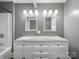 Bathroom featuring double sink vanity with granite countertop and mosaic mirrors at 322 Peachtree St, Albemarle, NC 28001