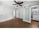 Bedroom featuring dark wood floors and barn door to bathroom at 322 Peachtree St, Albemarle, NC 28001