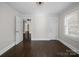 Bedroom with dark wood floors, window, and closet at 322 Peachtree St, Albemarle, NC 28001